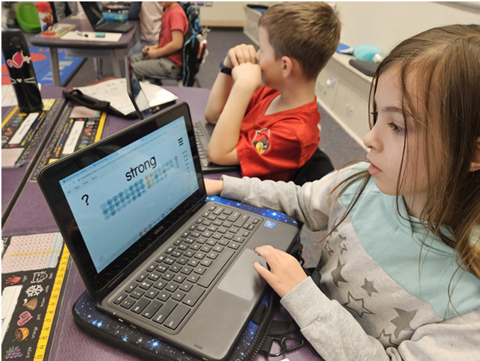 Student uses Chromebook for spelling activity.
