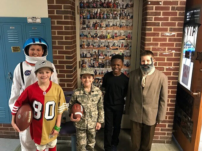 Five students dressed in costumes.
